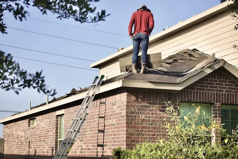 Professional roofer working on a residential roof in Stanchfield